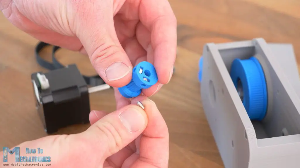 3D Printed GT2 pulley with slots for nuts for securing it to a NEMA 17 shaft with grub screws